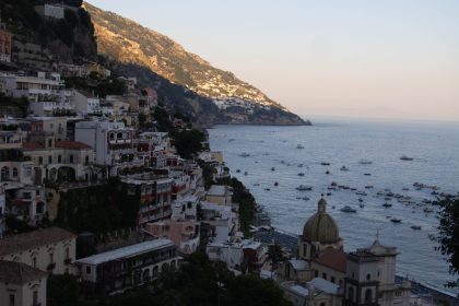 Positano at sunset with warm lights over the coast, the perfect setting for dinner